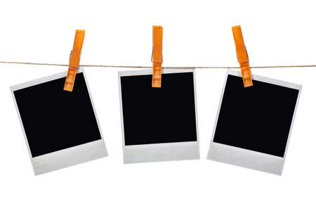 Black instant photo, hanging on the clothesline, isolated on white background.の写真素材