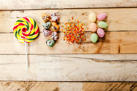 Different colorful sweets and lollipops on the wooden table.の写真素材
