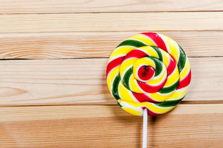 Single lollipop on wooden background.の写真素材