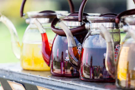Many teapots with different colors fruit tastes of tea.の写真素材