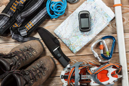 Equipment for mountaineering and hiking on wooden background.の写真素材