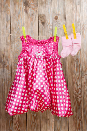 Cute child dress with socks on wooden background. Kids concept.の写真素材