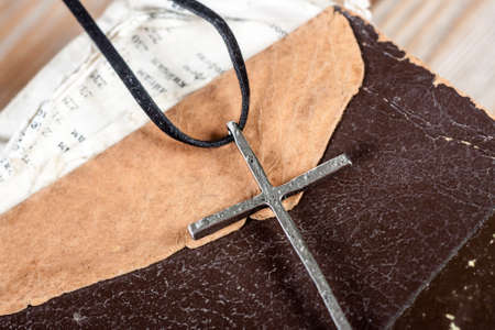 Silver christian cross on bible. Religious concept.