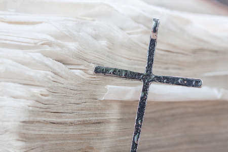 Silver christian cross on bible. Religious concept.の写真素材