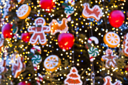 Christmas tree with ornaments of baubles, snowflakes, teddy bears, sleighs, gingerbread man, pine...