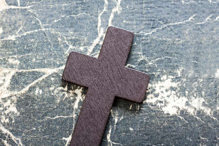 Wooden Christian cross on bible. Religious symbols concept.の写真素材
