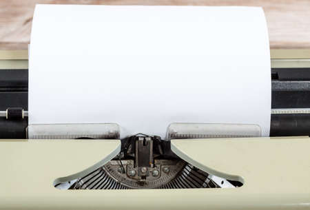 Old vintage antique typewriter machine with paper for text. Writer creation concept.
