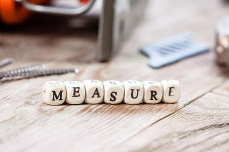 Word MEASURE written on a wooden block. Work tools concept.の写真素材
