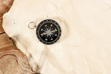 Old map with compass on old wooden background.の写真素材