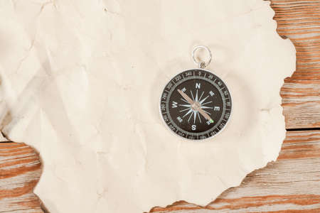 Old map with compass on old wooden background.の写真素材