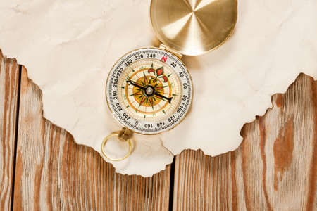 Old map with compass on old wooden background.の写真素材