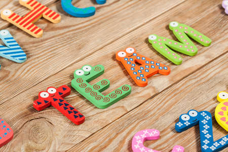 Word TEAM letters on old wooden board background.の写真素材
