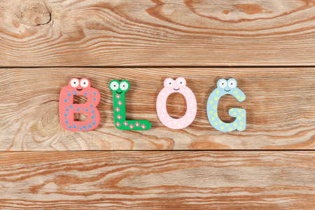 Word BLOG letters on old wooden board background.の写真素材