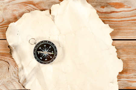 Old map with compass on old wooden background.の写真素材