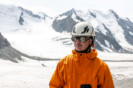 Hiker relaxing on top of a mountain and enjoying valley view. Tien Shan mountains, central asia, Kyrgyzstan. Climbing and mountaineering concept.の写真素材