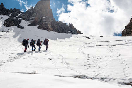 Group of hikers in Tien Shan mountains, central asia, Kyrgyzstan. Climbing and mountaineering concept.の写真素材