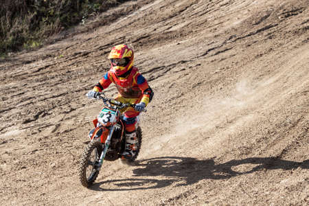 Kiev, Ukraine - October 17, 2016: Kid on motorcycle going thru dirt, during Championship of Ukraine on cross-country final stage.のeditorial素材