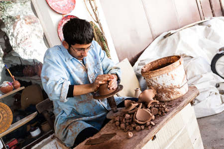 Cappadocia, Turkey - September 13, 2011: An unknown artist works on a traditional ceramic vase in Cappadocia, Turkey. Ceramics have a strong tradition in this part of Turkey.のeditorial素材