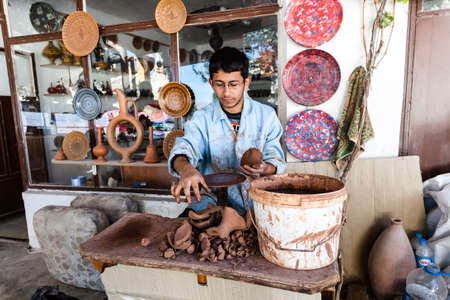 Cappadocia, Turkey - September 13, 2011: An unknown artist works on a traditional ceramic vase in Cappadocia, Turkey. Ceramics have a strong tradition in this part of Turkey.のeditorial素材
