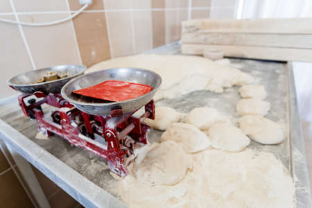 Round bread dough is waiting to be cooked in bakery.の写真素材