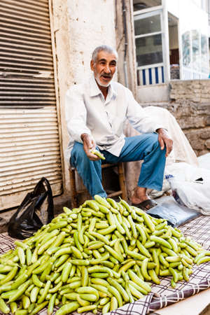 Mardin, Turkey - September 19, 2011: An unknown man sell cucumbers on market of Mardin.のeditorial素材