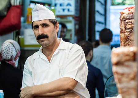 Istanbul, Turkey - September 6, 2011: Unknown man cooks and sells traditional kebab in a small buffet on streets of Istanbul.のeditorial素材