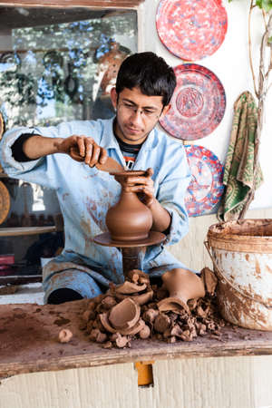 Cappadocia, Turkey - September 13, 2011: An unknown artist works on a traditional ceramic vase in Cappadocia, Turkey. Ceramics have a strong tradition in this part of Turkey.のeditorial素材