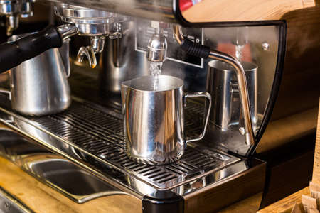 Barista preparing hot water for takeaway coffee, barista coffee preparation service concept.の写真素材