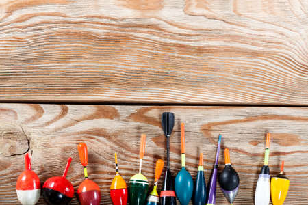 View of fishing accessories on old wooden table. Set of floats of different colors and different purposes.の写真素材