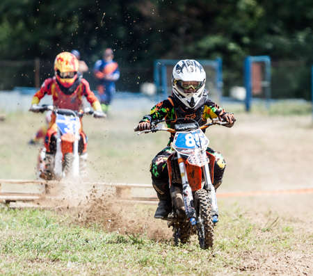 Kiev, Ukraine - July 16, 2017: Kid on motorcycle going thru dirt, during Championship of Ukraine on cross-country final stage.のeditorial素材