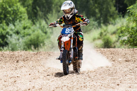 Kiev, Ukraine - July 16, 2017: Kid on motorcycle going thru dirt, during Championship of Ukraine on cross-country final stage.のeditorial素材