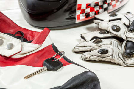 View of motorcycle rider accessories. Items included motorcycle helmet, gloves, keys and jacket. Motorcycle travel dream concept.の写真素材