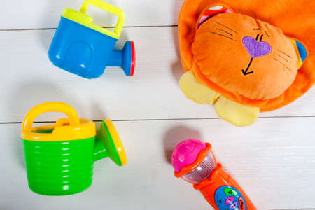 Colorful kids toys on white wooden background. Top view. Flat lay. Copy space for text.の写真素材