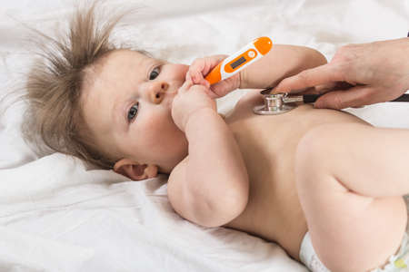 Doctor checks the condition of the child using stethoscope. Healthcare and medicine concept at...