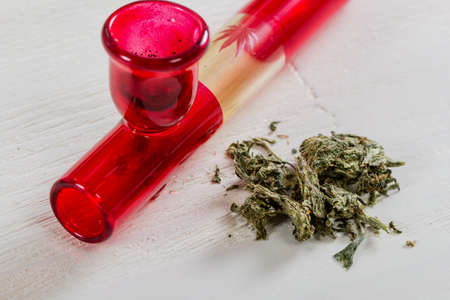 Medical marijuana cannabis buds with doctors prescription for weed. Pipe with stethoscope. Health care and medicine concept.の写真素材