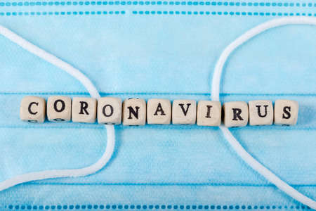 Coronavirus word written on wood block. what is coronavirus text on mask for your desing, coronavirus concept top view.の写真素材