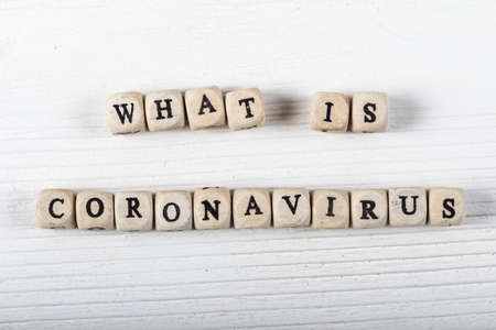 What is coronavirus word written on wood block. what is coronavirus text on wooden table for your desing, coronavirus concept top view.の写真素材