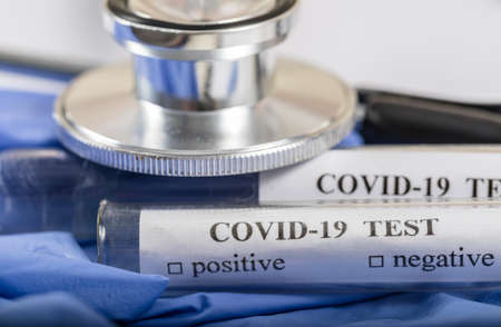 Coronavirus COVID-2019 test concept with blood test tubes, test form and other medical objectsの写真素材