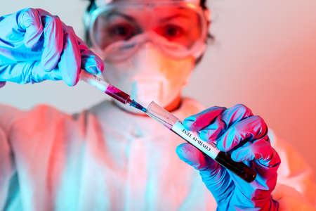 Doctor in protective making blood tests for Coronavirus COVID-19 analyzing.
