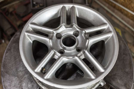 Process of tire repairing. Repair a tire from car by mechanic. Winter tires
