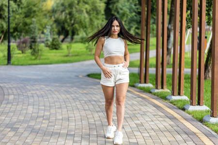 Attractive woman relaxing with her two adorable dogs.の写真素材