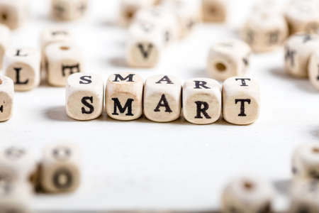 Word SMART formed by wood alphabet blocks. On old wooden table.の写真素材