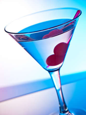 Glass of martini cocktail with cherriesの写真素材