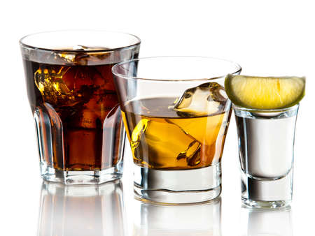 Cuba libre, whiskey on the rocks and tequila shotの写真素材