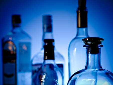 Various bottles at a bar arragged in rows
