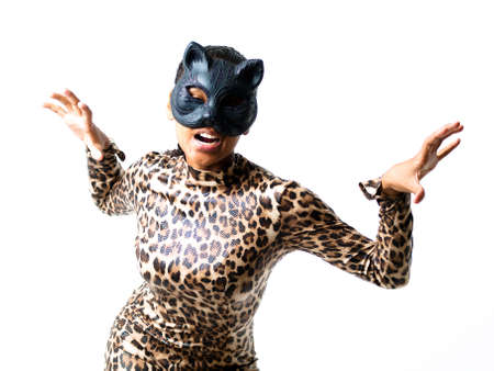 Dancer dressed in a leopard suit and cat mask; attacking and aggressiveの写真素材