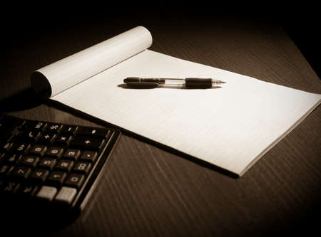 Notepad, pen and calculator; hard lightの写真素材