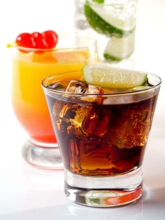 Various alcoholic cocktails on white background