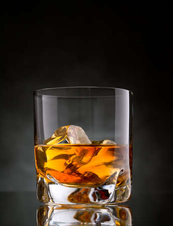 One glass of whisky on the rocks on black backgroundの写真素材