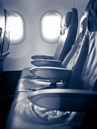 Inside a passenger aircraft, three seats